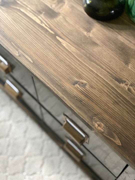 Create a DIY Industrial Coffee Table from an industrial metal drawer piece, some wood, stain and old casters to get the look you want for less!