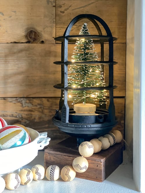 This DIY upcycled Christmas tree lantern was an easy project that repurposed an old light into a great piece of decor for the holidays!