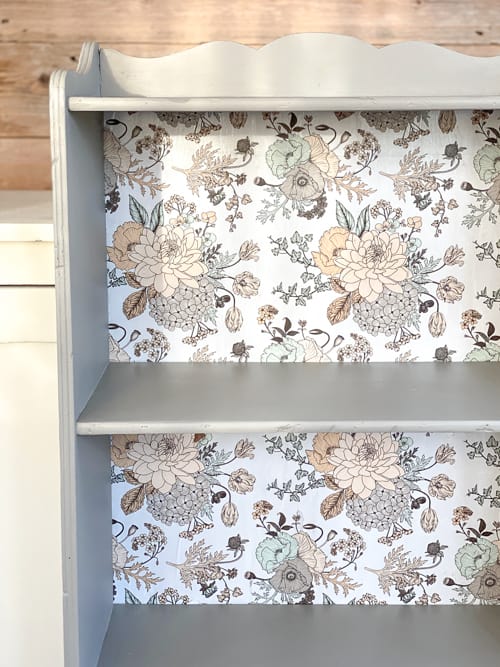 This vintage bookcase makeover used stripper, paint, and wrapping paper to update it and make it beautiful and functional for years to come.