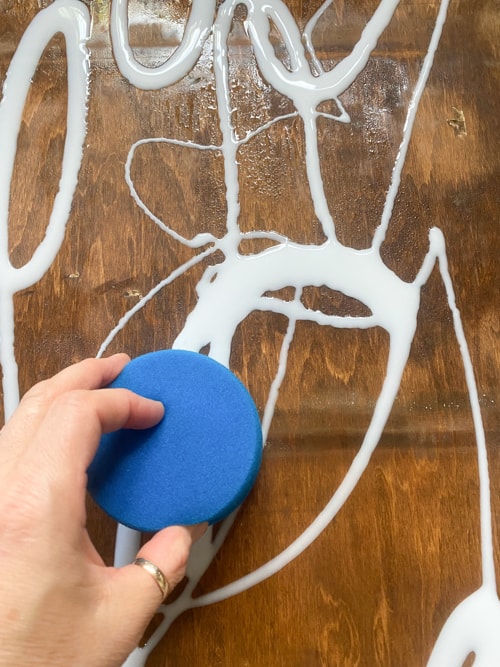 spreading glue on bookcase