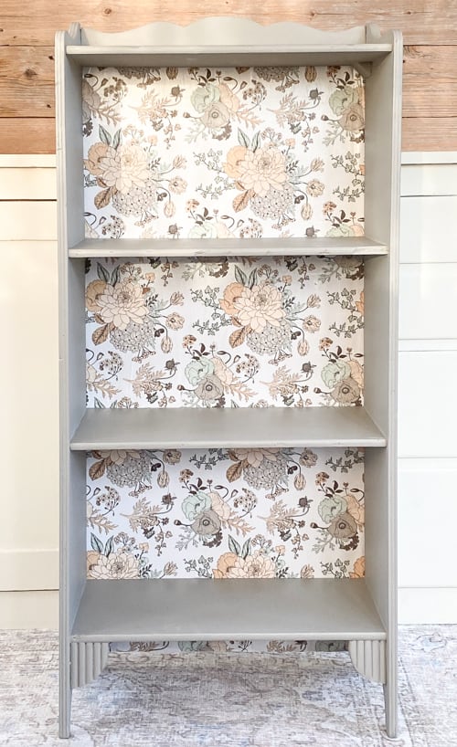 This vintage bookcase makeover used stripper, paint, and wrapping paper to update it and make it beautiful and functional for years to come.