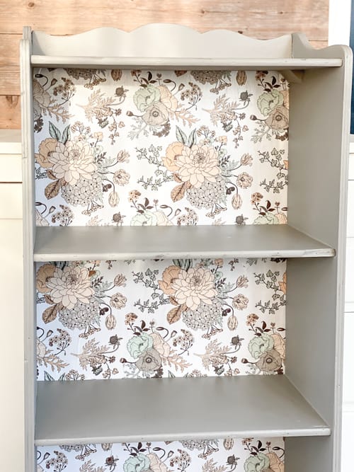 This vintage bookcase makeover used stripper, paint, and wrapping paper to update it and make it beautiful and functional for years to come.