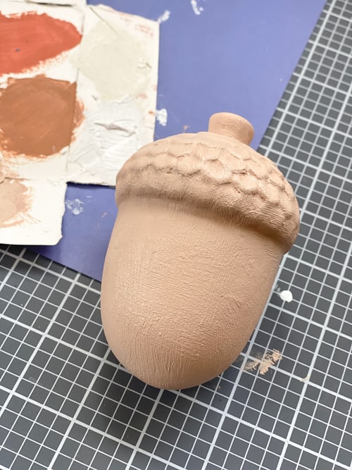 These DIY terra cotta acorns were very easy to make with two paint products and ceramic acorns from the dollar store.