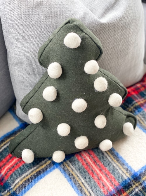 Looking for a cute Christmas pillow? Make a DIY Felted Pom-Pom Christmas Pillow on the cheap without any sewing and only a few supplies!