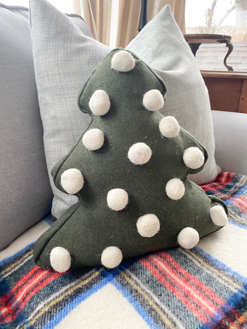 Looking for a cute Christmas pillow? Make a DIY Felted Pom-Pom Christmas Pillow on the cheap without any sewing and only a few supplies!