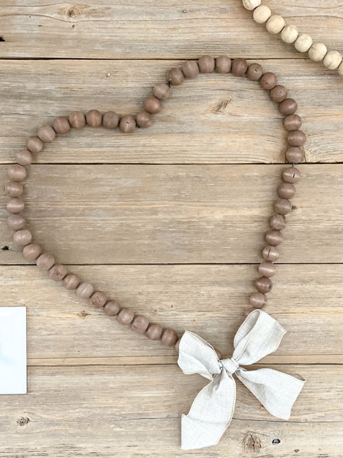 Looking for easy ways to decorate for Valentine's Day? These DIY Wood Bead Valentine Wreaths turn dollar store items into 3 pretty wreaths.