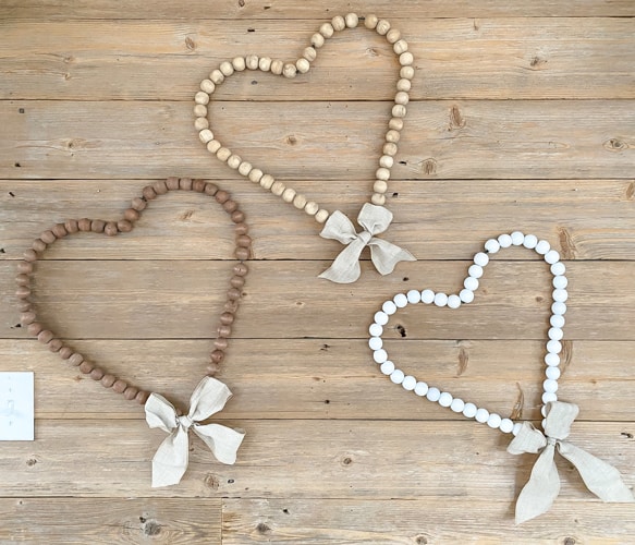 Looking for easy ways to decorate for Valentine's Day? These DIY Wood Bead Valentine Wreaths turn dollar store items into 3 pretty wreaths.