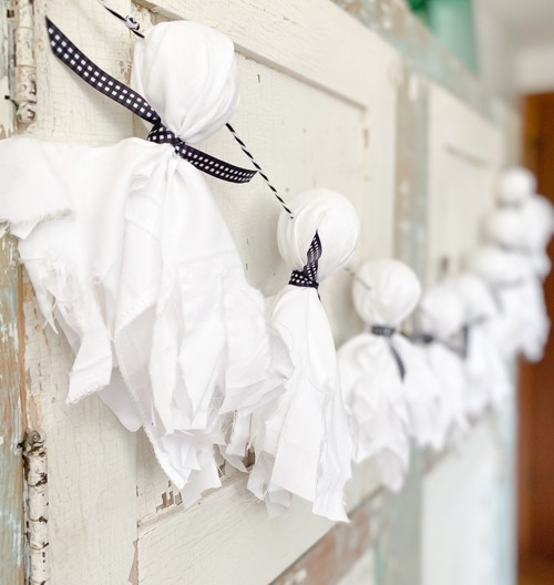 This DIY Dollar Store Ghost Garland is an easy and inexpensive project that will bring some spooky Halloween flair to your party or decor.