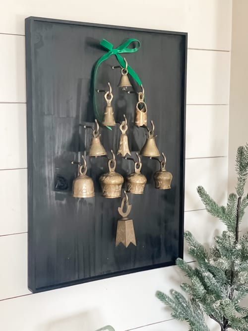 This DIY Bell Christmas Tree Display tutorial is a step-by-step guide on how to craft a whimsical tree adorned with antique bells.