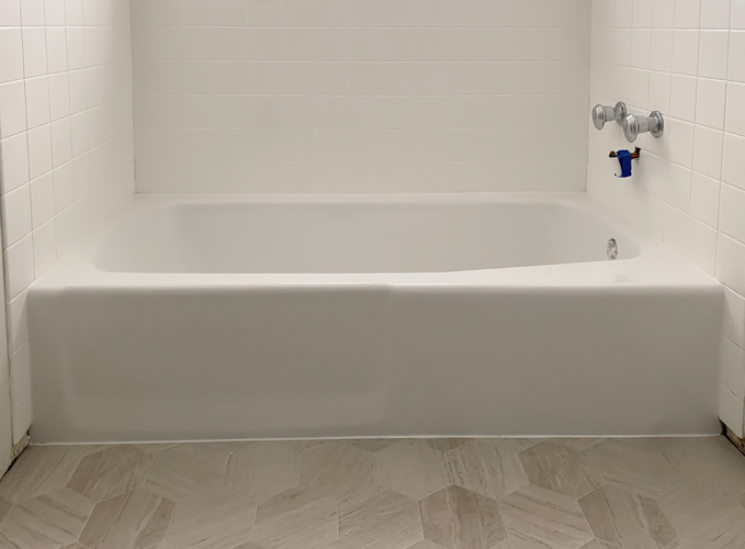 We turned a blue tub white in our flip with budget-friendly bathtub refinishing by Surface Specialists. It was fast, affordable, and a total bathroom game-changer.