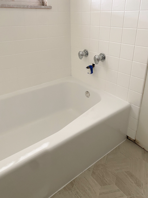 We turned a blue tub white in our flip with budget-friendly bathtub refinishing by Surface Specialists. It was fast, affordable, and a total bathroom game-changer.