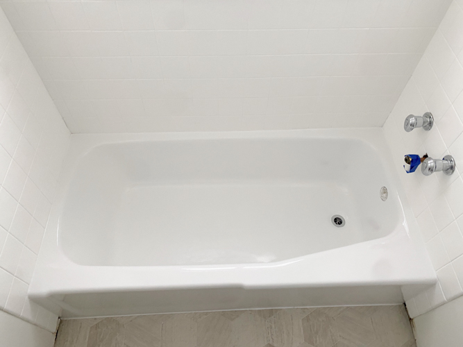 We turned a blue tub white in our flip with budget-friendly bathtub refinishing by Surface Specialists. It was fast, affordable, and a total bathroom game-changer.