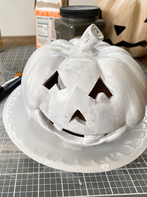 Create a DIY Black Terracotta Jack O’ Lantern Pottery Barn dupe for a fraction of the cost. Easy thrift flip tutorial with supplies and video tutorial.