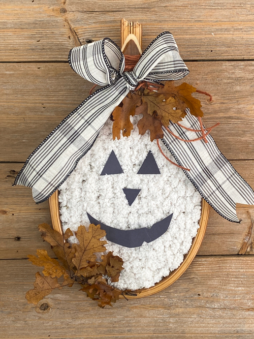 Turn a broken vintage racket into a DIY Tennis Racket Pumpkin! This easy upcycle makes the cutest fall wreath or wall decor for your home.