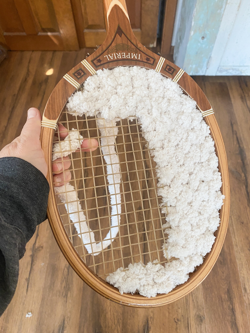 Turn a broken vintage racket into a DIY Tennis Racket Pumpkin! This easy upcycle makes the cutest fall wreath or wall decor for your home.