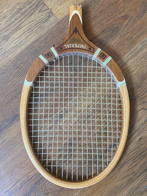 Turn a broken vintage racket into a DIY Tennis Racket Pumpkin! This easy upcycle makes the cutest fall wreath or wall decor for your home.