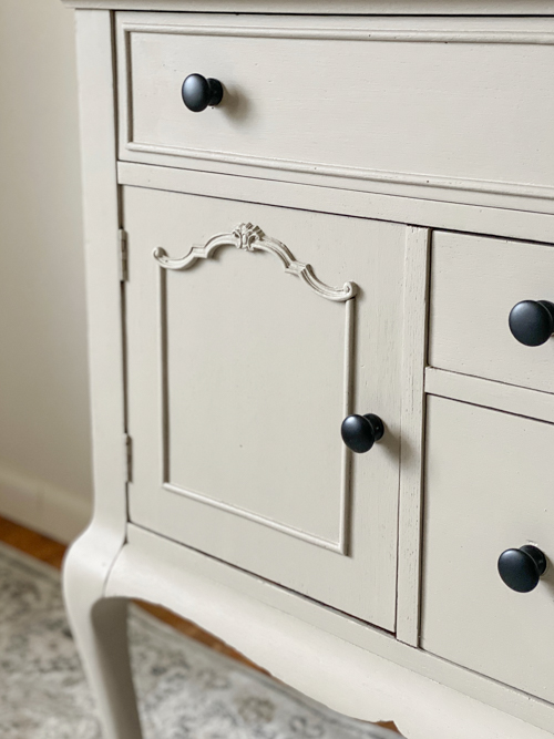 See how this French Country Buffet Makeover turned an outdated piece into a stunning focal point with French Linen paint and black hardware.