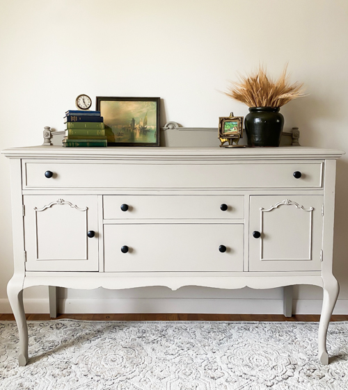 See how this French Country Buffet Makeover turned an outdated piece into a stunning focal point with French Linen paint and black hardware.