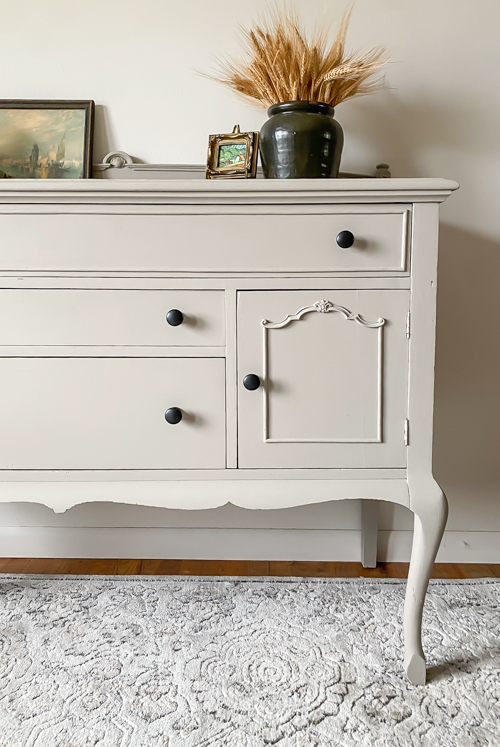 See how this French Country Buffet Makeover turned an outdated piece into a stunning focal point with French Linen paint and black hardware.