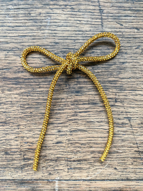 DIY Rhinestone Bow Christmas Ornaments add sparkle and style to your holiday décor. Easy, affordable, and perfect for this year’s trending bow look!