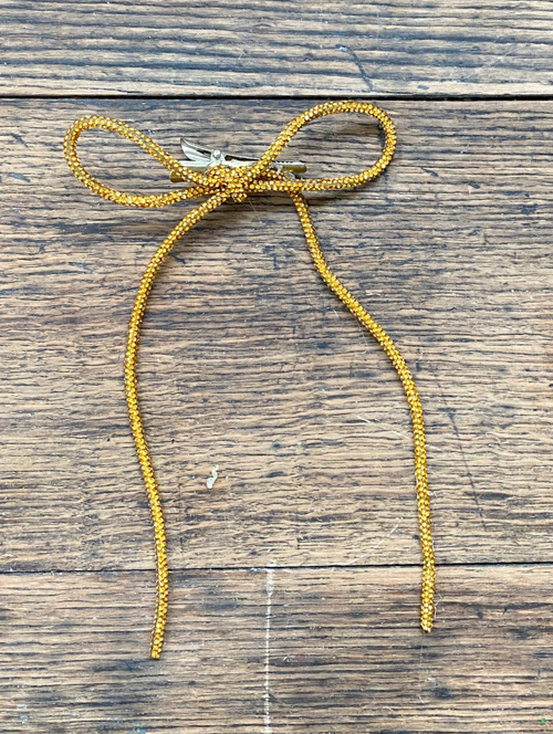 DIY Rhinestone Bow Christmas Ornaments add sparkle and style to your holiday décor. Easy, affordable, and perfect for this year’s trending bow look!