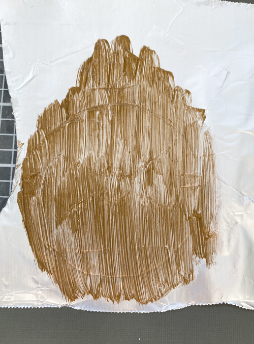 Learn how to make DIY vintage tin ornaments with aluminum foil, cardstock, and paint for a charming, antique-inspired Christmas look.