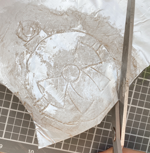 Learn how to make DIY vintage tin ornaments with aluminum foil, cardstock, and paint for a charming, antique-inspired Christmas look.