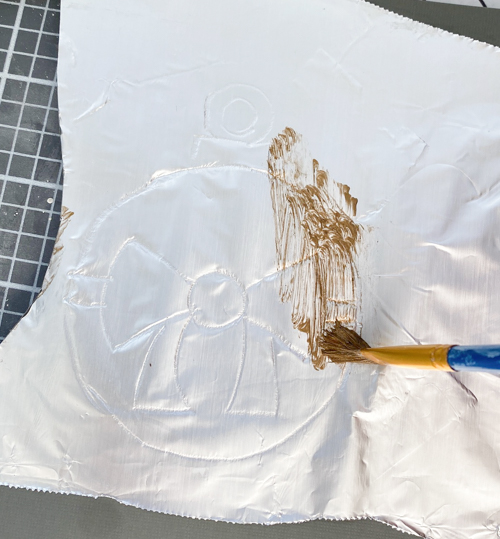 Learn how to make DIY vintage tin ornaments with aluminum foil, cardstock, and paint for a charming, antique-inspired Christmas look.