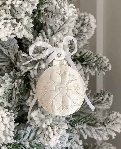 Learn how to make DIY vintage tin ornaments with aluminum foil, cardstock, and paint for a charming, antique-inspired Christmas look.