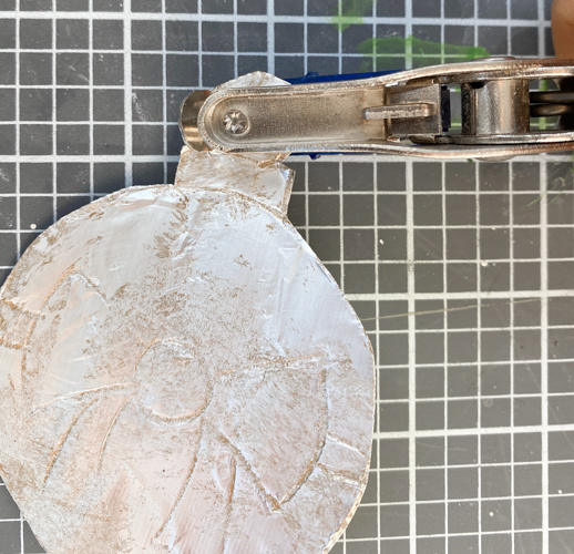 Learn how to make DIY vintage tin ornaments with aluminum foil, cardstock, and paint for a charming, antique-inspired Christmas look.