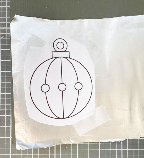 Learn how to make DIY vintage tin ornaments with aluminum foil, cardstock, and paint for a charming, antique-inspired Christmas look.