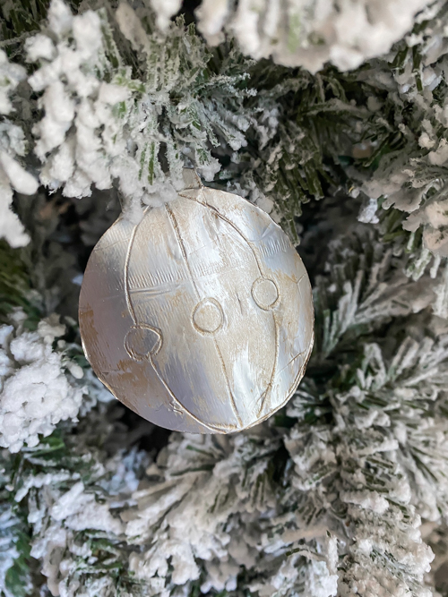 Learn how to make DIY vintage tin ornaments with aluminum foil, cardstock, and paint for a charming, antique-inspired Christmas look.