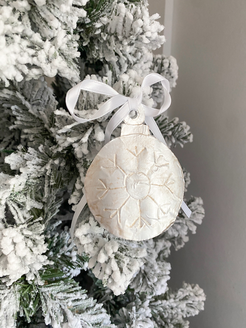 Learn how to make DIY vintage tin ornaments with aluminum foil, cardstock, and paint for a charming, antique-inspired Christmas look.