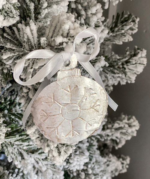 Learn how to make DIY vintage tin ornaments with aluminum foil, cardstock, and paint for a charming, antique-inspired Christmas look.