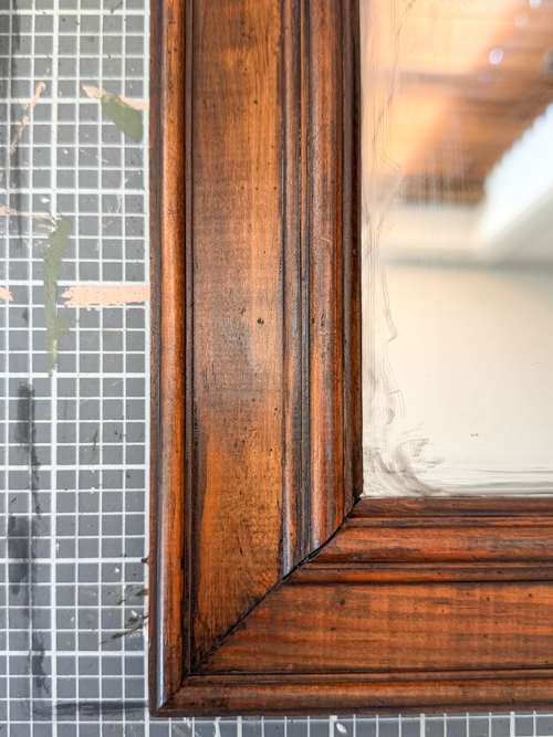 This Black Paint Wash Technique adds age and charm to a thrifted mirror. An easy DIY paint wash that highlights wood grain and character.