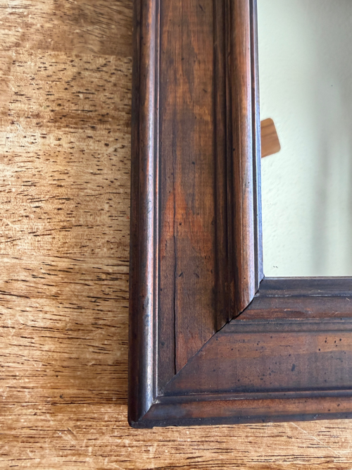 This Black Paint Wash Technique adds age and charm to a thrifted mirror. An easy DIY paint wash that highlights wood grain and character.