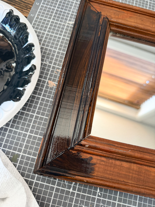 This Black Paint Wash Technique adds age and charm to a thrifted mirror. An easy DIY paint wash that highlights wood grain and character.