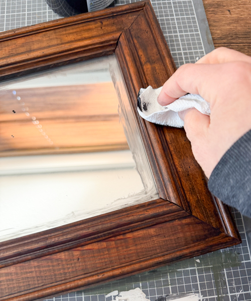 This Black Paint Wash Technique adds age and charm to a thrifted mirror. An easy DIY paint wash that highlights wood grain and character.