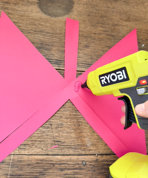 Learn how easy it is to make DIY paper bows with hot glue, paper, and scissors. Make them for birthdays, gifts, Valentine's Day decor, or turn them into garlands.