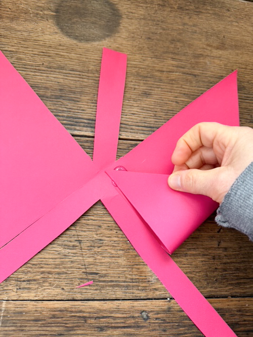 Learn how easy it is to make DIY paper bows with hot glue, paper, and scissors. Make them for birthdays, gifts, Valentine's Day decor, or turn them into garlands.