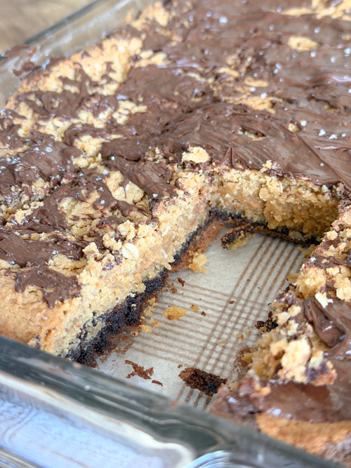 Indulge in these decadent Layered Peanut Butter Brownie Bars with chewy oatmeal, rich chocolate, and gooey peanut butter layers. Perfect for anytime treats!