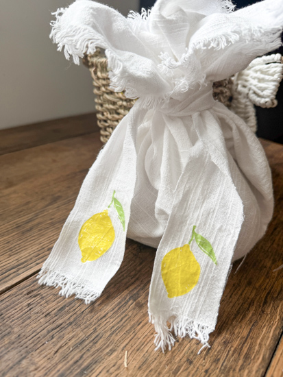 Learn how to decoupage fabric with napkins using an easy iron-on method, no glue needed! Create custom placemats, ribbon, and more with this DIY.