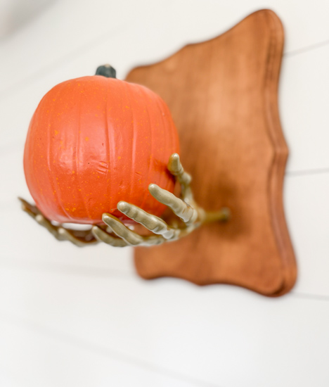 DIY Dollar Store Halloween Decoration tutorial using Dollar Tree supplies to make a unique pumpkin holder wall hanging that looks high-end for less.