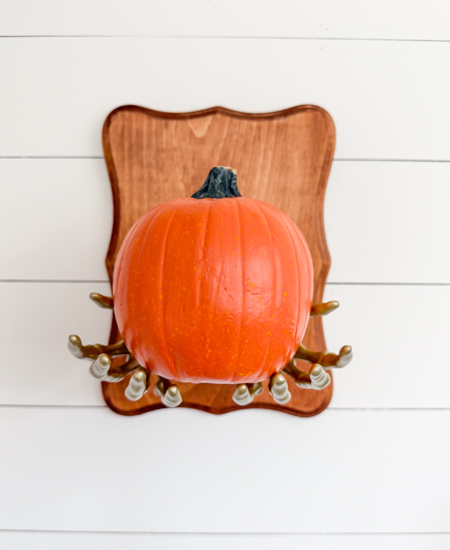 DIY Dollar Store Halloween Decoration tutorial using Dollar Tree supplies to make a unique pumpkin holder wall hanging that looks high-end for less.