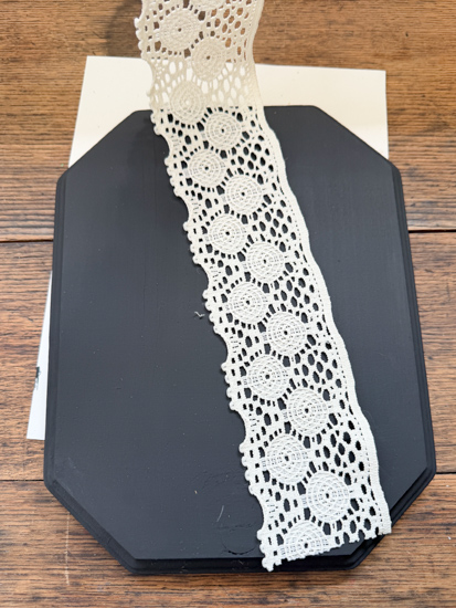 DIY Halloween Ghost Decor is easy to make with a wood plaque, lace trim, and a few simple supplies. Create this cute DIY ghost wall hanging on a budget.