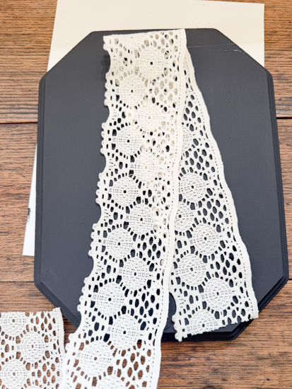 DIY Halloween Ghost Decor is easy to make with a wood plaque, lace trim, and a few simple supplies. Create this cute DIY ghost wall hanging on a budget.