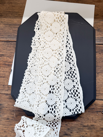 DIY Halloween Ghost Decor is easy to make with a wood plaque, lace trim, and a few simple supplies. Create this cute DIY ghost wall hanging on a budget.